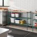 A school kitchen with a Regency green epoxy shelving unit on a counter.