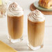 Two glasses of Crown Beverages French Roast coffee with whipped cream on top.