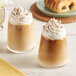 Two glasses of Crown Beverages Organic Breakfast Blend coffee with whipped cream on top.