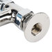 A close-up of a T&amp;S deck-mounted faucet with metal pipes and lever handles.