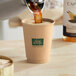 New Roots double wall paper hot cup being filled with coffee.
