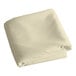 An ivory hemmed cloth table cover folded on a white background.