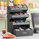 A black ServSense countertop organizer with 15 sections for condiments.