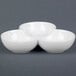A white three-tiered bowl with three bowls.