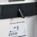 A stainless steel Bunn iced tea brewer with a black and white label that says "use quick brew funnel" on it.