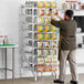 A man standing by a Steelton aluminum can rack filled with cans.