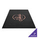 A black Guardian Prestige entrance mat with pink lettering on it.