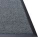 A close up of a Guardian EliteGuard Berber carpet entrance mat with a black border.