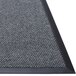 A customizable Berber carpet entrance mat with rubber backing and a black border.