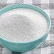 A bowl of Extra Fine Granulated Cane Sugar on a checkered tablecloth.