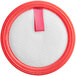 A round white sponge filter with a red circle and a pink ribbon.