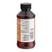 A close-up of a brown LorAnn Oils Caramel Bakery Emulsion bottle with a white label.