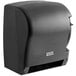 A Lavex translucent black paper towel dispenser with a black lever.