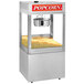 A Cretors floor model popcorn machine with a large bowl of popcorn inside.