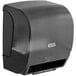 A black Lavex automatic paper towel dispenser on a wall.