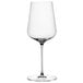 A close-up of a clear Spiegelau wine glass with a stem.