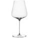 A close-up of a clear Spiegelau Bordeaux wine glass with a stem.