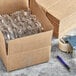 A Lavex shipping box with plastic wrap inside and a pen.