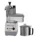 A Robot Coupe commercial food processor with a stainless steel bowl and a lid.