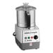 A silver Robot Coupe food processor with a clear lid.