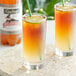 A close up of two glasses of Goslings Diet Ginger Beer with limes and straws.