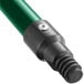 A close-up of a green Lavex metal broom handle with black screw.