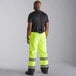 A man wearing Cordova hi-vis yellow quilted bib pants.