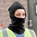 A woman wearing a Cordova black polar fleece face mask.