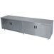 A long stainless steel cabinet with an enclosed base and hinged doors.