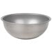 A close-up of a silver Vollrath stainless steel mixing bowl with a rim.