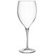 A close-up of a Luigi Bormioli Magnifico clear wine glass with a long stem.