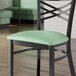 A Lancaster Table & Seating seafoam green vinyl padded seat for metal frame seating.