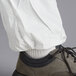 A person wearing white Malt ProMax coveralls with white shoes.