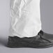 A person wearing white Malt Impact coveralls with open wrists and ankles.