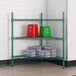 A green metal shelving unit with red buckets and several packages.