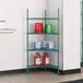 A green metal Regency wire shelf with containers on it.