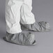 a person wearing white pants and white pants with grey shoes