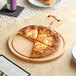 A slice of pizza on a Boska beech wood serving board.