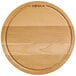 A Boska round beech wood serving board.