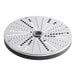 A stainless steel circular food processor disc with holes.