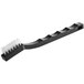 A Lavex toothbrush style grout brush with a black handle and clear bristles.