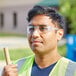 A man wearing Honeywell Uvex safety glasses and a reflective vest.