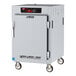 A white Metro C5 series heated holding cabinet with wheels and a solid door.