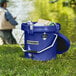 A navy CaterGator outdoor cooler filled with ice and drinks.