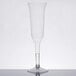 A clear plastic WNA Comet champagne flute with a stem on a table.