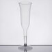 A clear plastic champagne flute on a table.