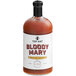 A bottle of Top Hat Provisions Bloody Mary Mix with a white label on a table in a cocktail bar.