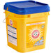 a yellow bucket with blue lid