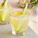 Two glasses of Top Hat Provisions Classic Tonic with cucumber and lemon slices on top.