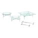 A glass table with a stainless steel riser on it.
